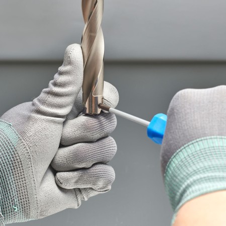 Clamp the insert pushing it with a hand not to separate from the holder